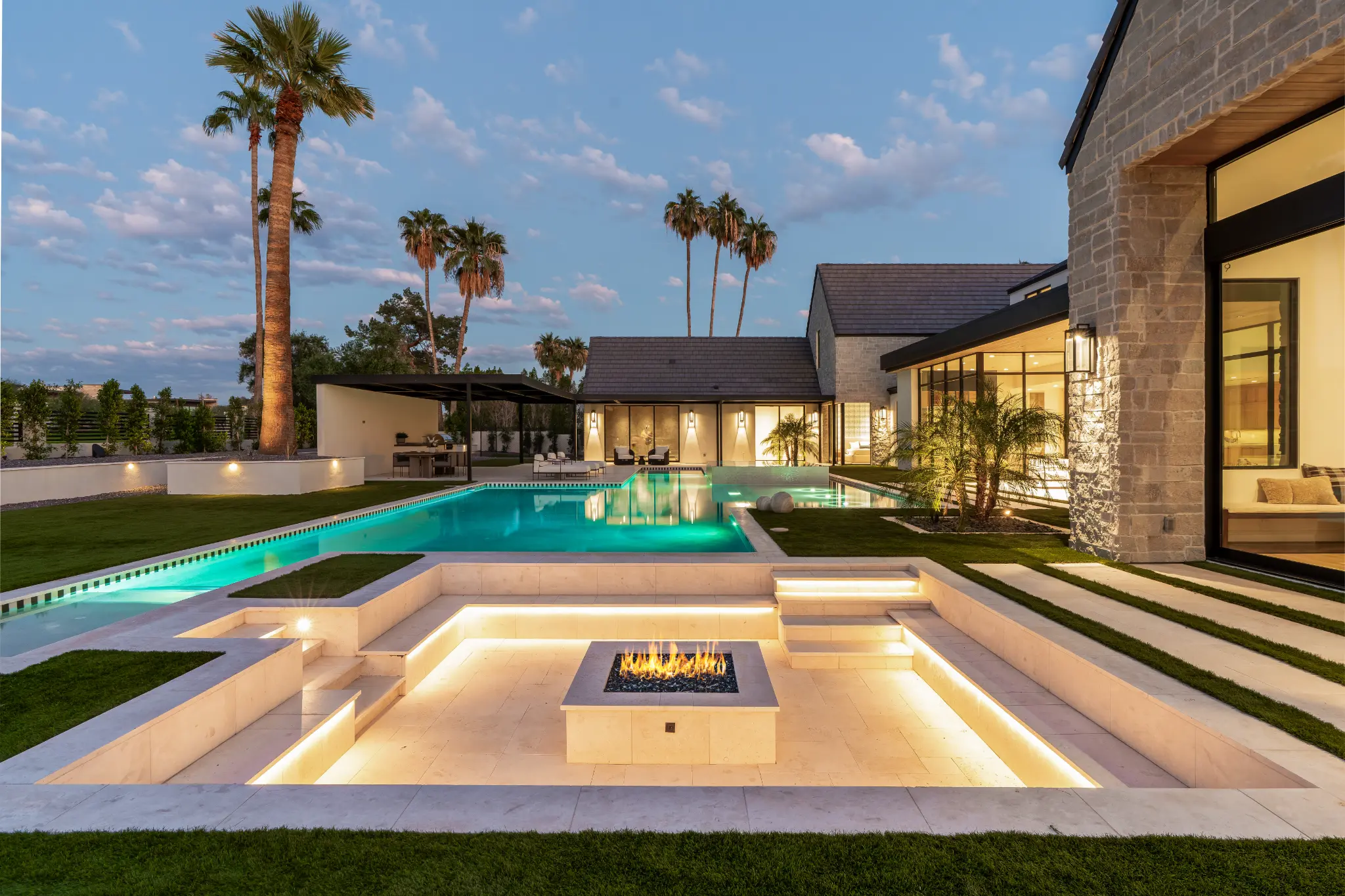 Modern outdoor living area with pool and fire feature