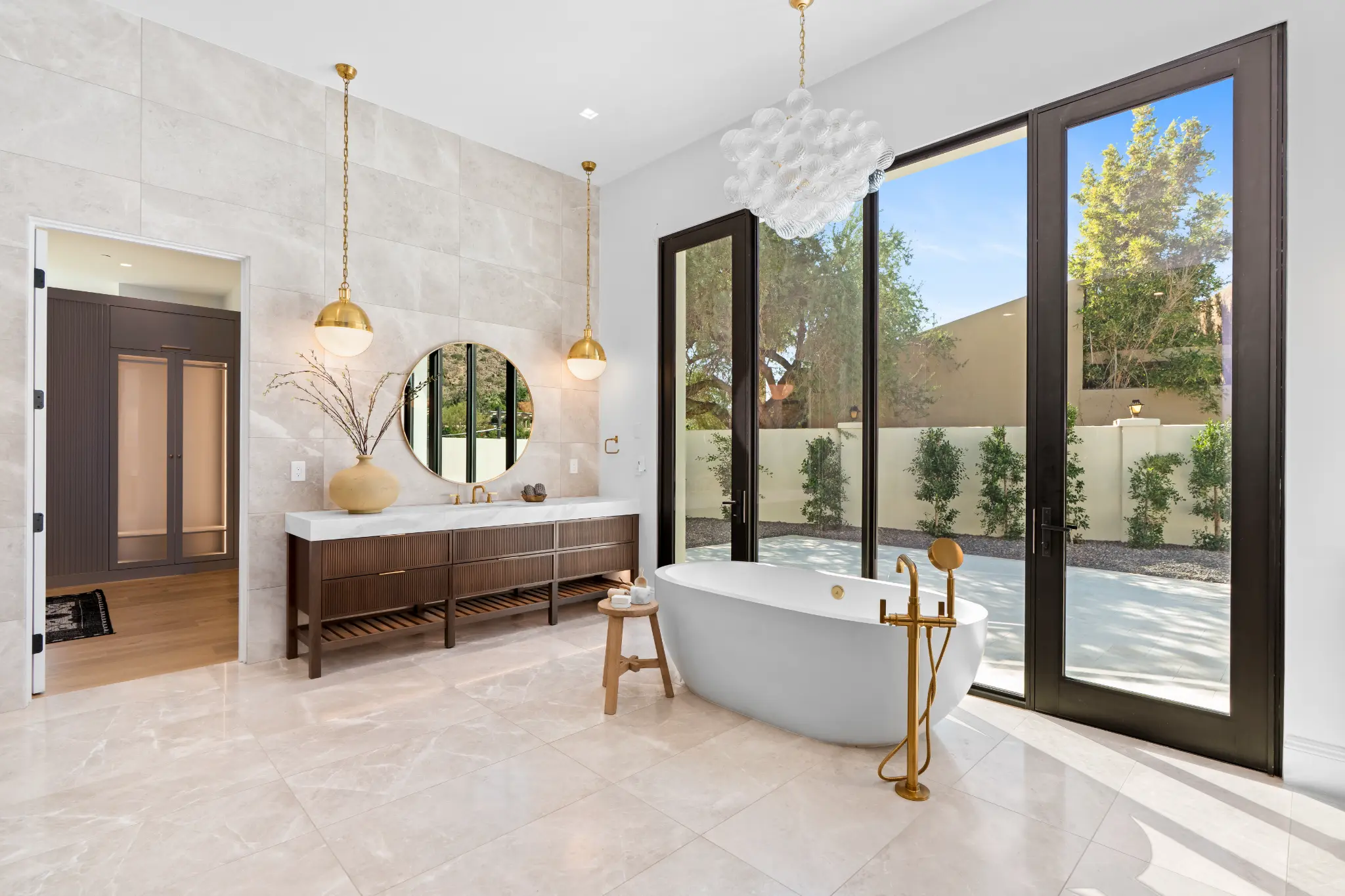 Custom bathroom vanity with book-matched stone basin and fluted wood cabinetry